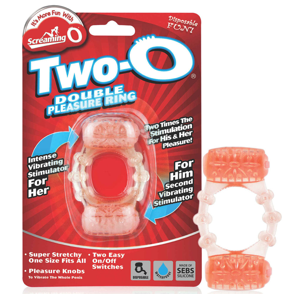 The image shows a red and transparent vibrating cock ring, packaged in a product box. The ring has two pleasure knobs and is designed for dual stimulation.