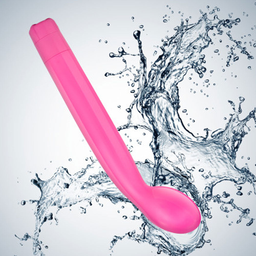 A pink G-slim vibrator with a curved tip and a deep handle, shown in a water splash, indicating its waterproof feature.