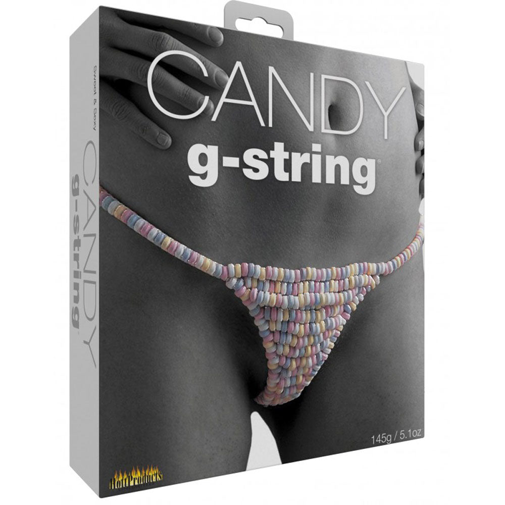 This image displays the packaging for the "Candy G-String," an edible g-string thong that is designed to be worn during intimate moments. The g-string is crafted from small, multicolored candy pieces, arranged in a pattern that resembles a traditional bikini design.