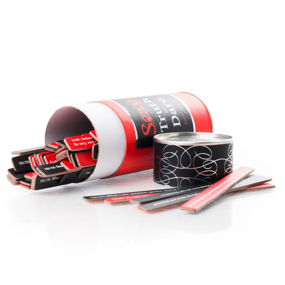 Sexy truth or dare party game opned with the top off. shows what pick up sticks look like. On a white background
