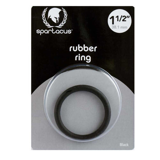 A black rubber cock ring, 1.5 inches in diameter, packaged in a clear plastic case with a black and white card header displaying the brand name 'Spartacus' and product information.