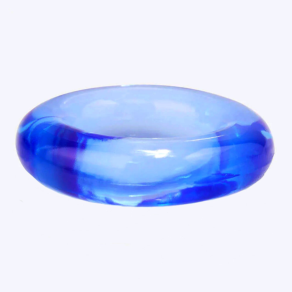 A textured photo of a blue cock ring from the Screaming O Ring O's package against a white background.