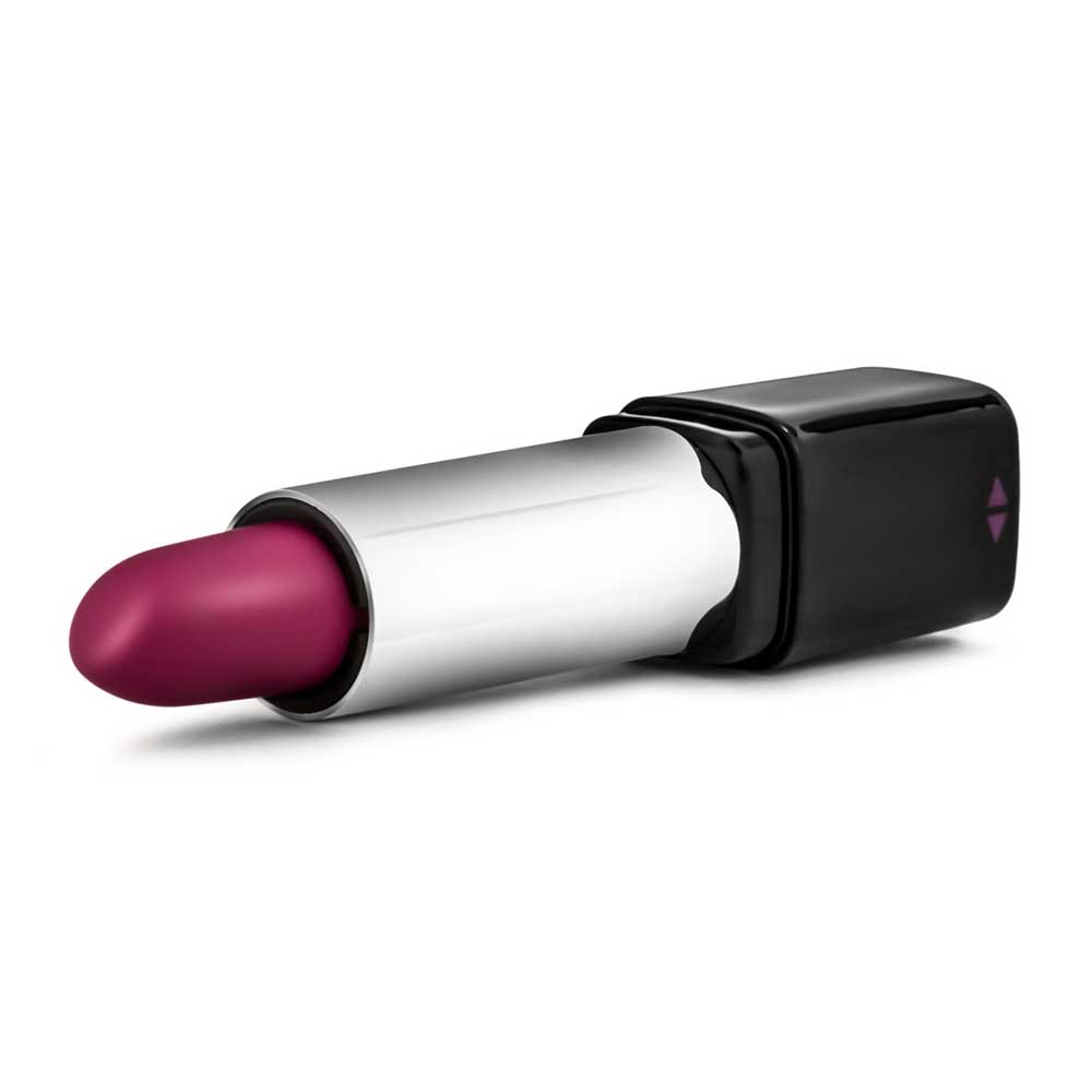An image of the Blush vibrator by Rosé. The image shows a purple lipstick-shaped vibrator lying horizontally against a white background.