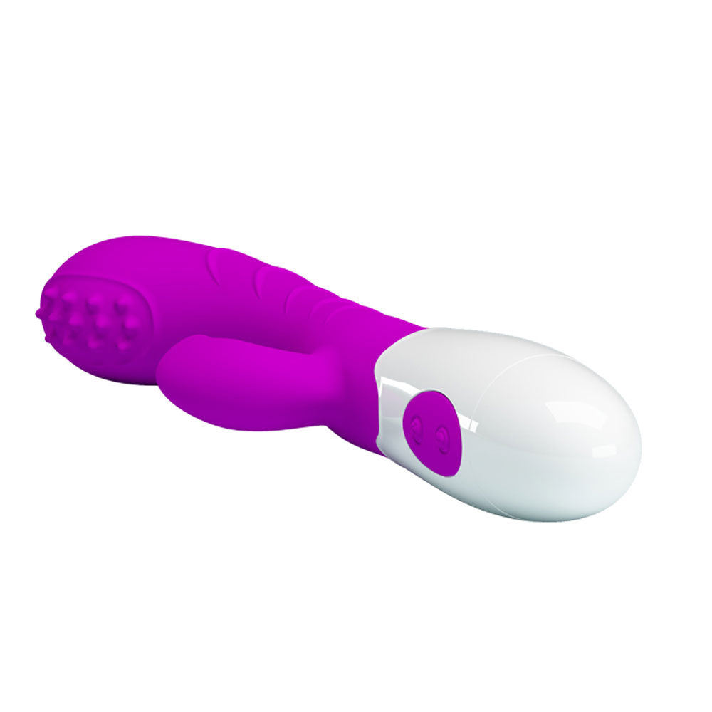 A purple and white rabbit style vibrator with a rolling ball tip and an external extension for clitoral and G-Spot stimulation lying horizontally against a white background.